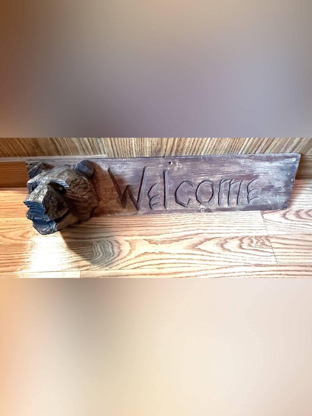 A rustic handmade wooden sign with a carved bear head  & sign says : (WELCOME)